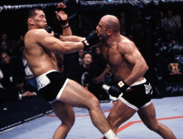 Bas Rutten (R) punches Tsuyoshi Kosaka during their bout at UFC 18 on January 8, 1999 in Kenner, Louisiana. (Photo by Josh Hedges/Zuffa LLC)
