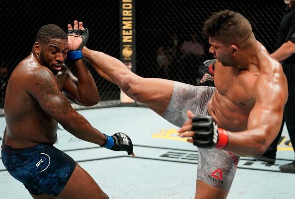 Alistair Overeem of the Netherlands kicks Walt Harris in their heavyweight fight during the UFC Fight Night event at VyStar Veterans Memorial Arena on May 16, 2020 in Jacksonville, Florida. (Photo by Cooper Neill/Zuffa LLC)