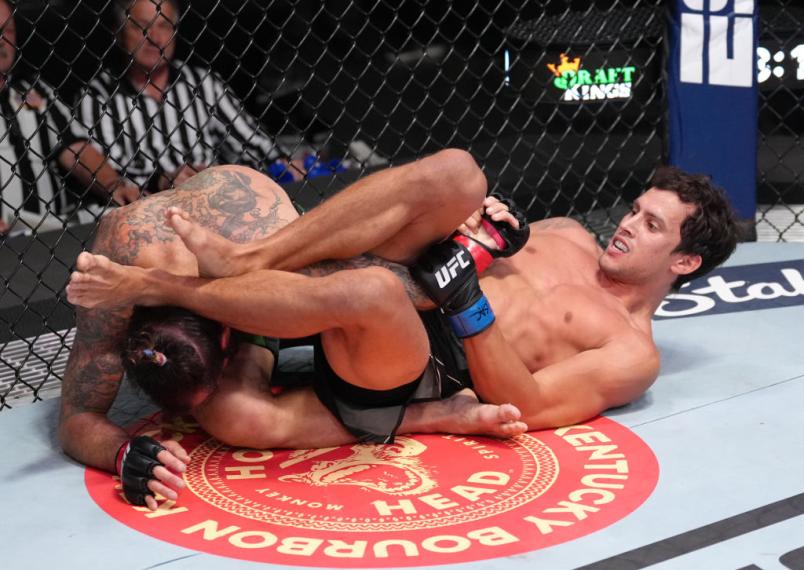 Claudio Puelles of Peru works for a submission against Clay Guida in a lightweight fight during the UFC Fight Night event at UFC APEX on April 23, 2022 in Las Vegas, Nevada. (Photo by Jeff Bottari/Zuffa LLC)