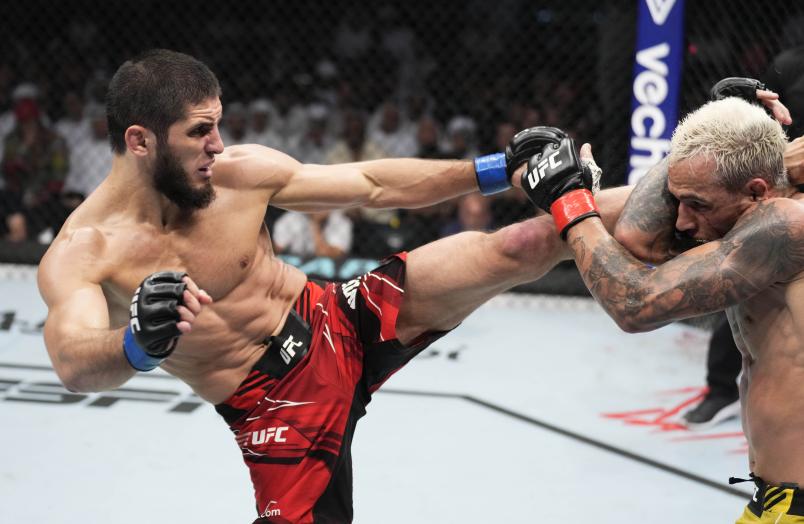 Islam Makhachev of Russia kicks Charles Oliveira of Brazil in their UFC lightweight championship fight during the UFC 280 event at Etihad Arena