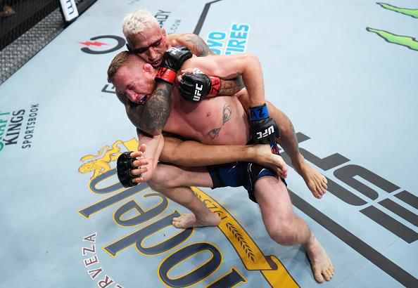 Charles Oliveira of Brazil secures a rear choke submission against Justin Gaethje in the UFC lightweight championship fight during the UFC 274 event at Footprint Center on May 07, 2022 in Phoenix, Arizona. (Photo by Chris Unger/Zuffa LLC)