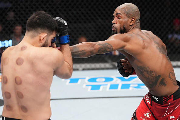 Bobby Green punches Nasrat Haqparast of Germany in their lightweight fight during the UFC 271 event at Toyota Center on February 12, 2022 in Houston, Texas. (Photo by Josh Hedges/Zuffa LLC)