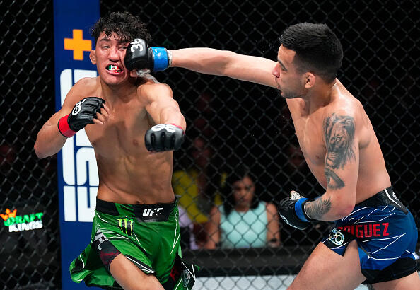 Christian Rodriguez punches Raul Rosas Jr. in a bantamweight fight during the UFC 287 event at Kaseya Center on April 08, 2023 in Miami, Florida. (Photo by Jeff Bottari/Zuffa LLC)