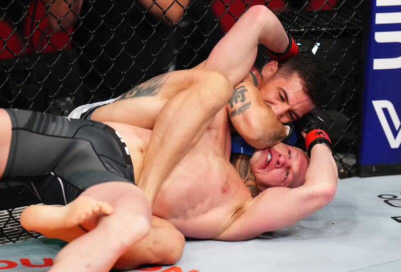 Gabriel Miranda of Brazil secures a rear choke submission against Shane Young of New Zealand in a featherweight fight during the UFC 293 event at Qudos Bank Arena on September 10, 2023 in Sydney, Australia. (Photo by Chris Unger/Zuffa LLC)