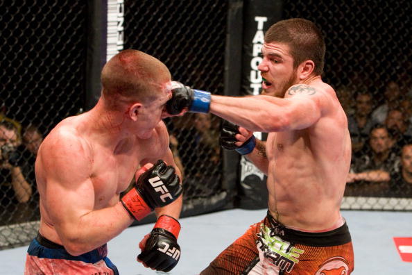 Jim Miller (orange/black shorts) def. Mac Danzig (blue/white shorts) - Unanimous Decision during UFC 100 at Mandalay Bay Events Center on July 11, 2009 in Las Vegas, Nevada. (Photo by Josh Hedges/Zuffa LLC)