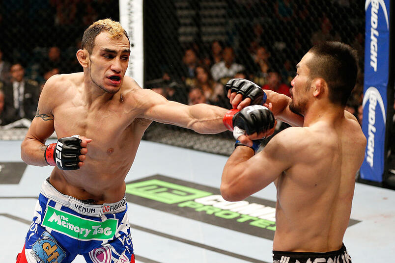 Tony Ferguson punches Katsunori Kikuno in their lightweight bout during the UFC 173 event at the MGM Grand Garden Arena on May 24, 2014 in Las Vegas, Nevada. (Photo by Josh Hedges/Zuffa LLC)