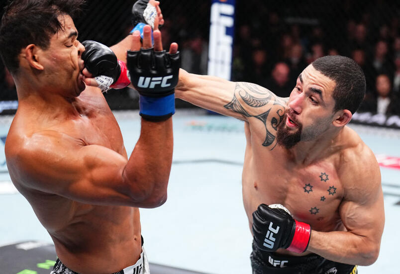 Robert Whittaker of New Zealand punches Paulo Costa of Brazil in a middleweight fight during the UFC 298 event at Honda Center on February 17, 2024 in Anaheim, California. (Photo by Chris Unger/Zuffa LLC)