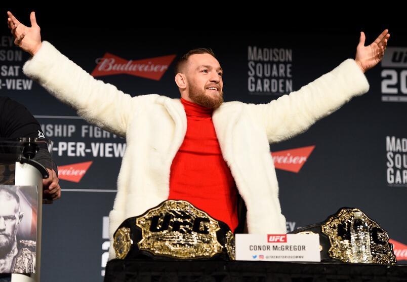 Conor McGregor of Ireland takes the belt of lightweight champion Eddie Alvarez (not pictured) during the UFC 205 press conference inside The Theater at Madison Square Garden on November 10, 2016 in New York City. 