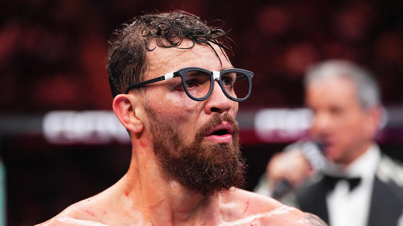 Mauricio Ruffy wearing fighting nerds glasses waiting for his fight result at UFC 309