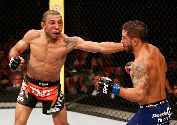 RIO DE JANEIRO, BRAZIL - OCTOBER 25:  (L-R) Jose Aldo of Brazil punches Chad Mendes in their featherweight championship bout during the UFC 179 event at Maracanazinho on October 25, 2014 in Rio de Janeiro, Brazil.  (Photo by Josh Hedges/Zuffa LLC/Zuffa LL