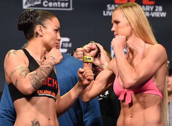 LOS ANGELES, CA - FEBRUARY 27:  (L-R) Opponents Raquel Pennington and Holly Holm face off during the UFC 184 weigh-in at the Event Deck and LA Live on February 27, 2015 in Los Angeles, California. (Photo by Josh Hedges/Zuffa LLC/Zuffa LLC via Getty Images