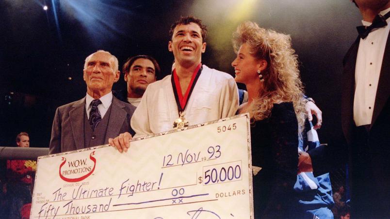 Jiu-Jitsu black belt Royce Gracie receives a $50,000 check after becoming "The Ultimate Fighter" by defeating Gerard Gordeau of the Netherlands int he finals of the Ultimate Fighter Championships in Denver, Colorado.  Mandatory Credit: Markus Boesch