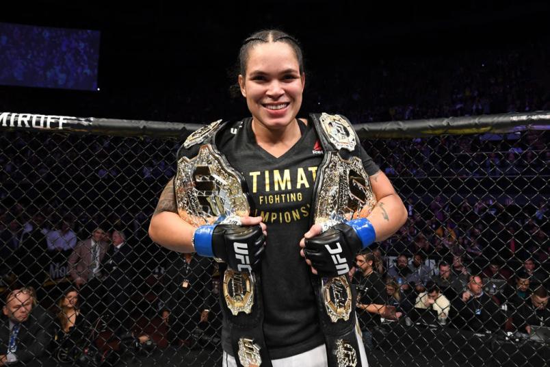 Amanda Nunes with her two belts at UFC 232