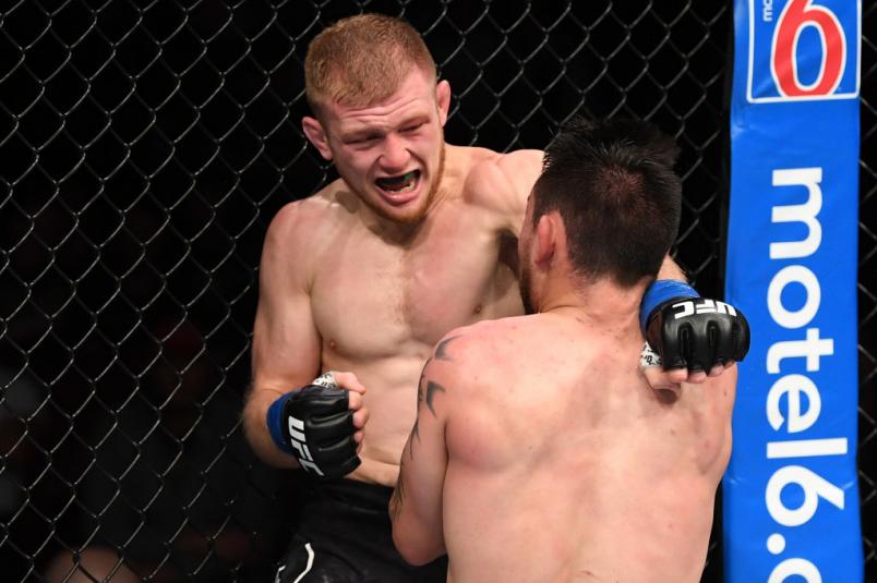 Casey Kenney punches Ray Borg in their bantamweight bout during the UFC Fight Night Event