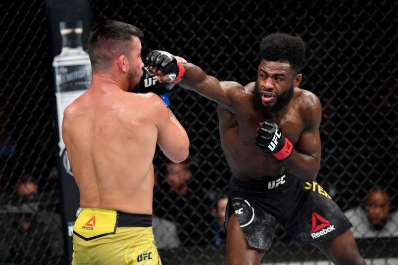 Aljamain Sterling punches Pedro Munhoz of Brazil in their bantamweight bout during the UFC 238