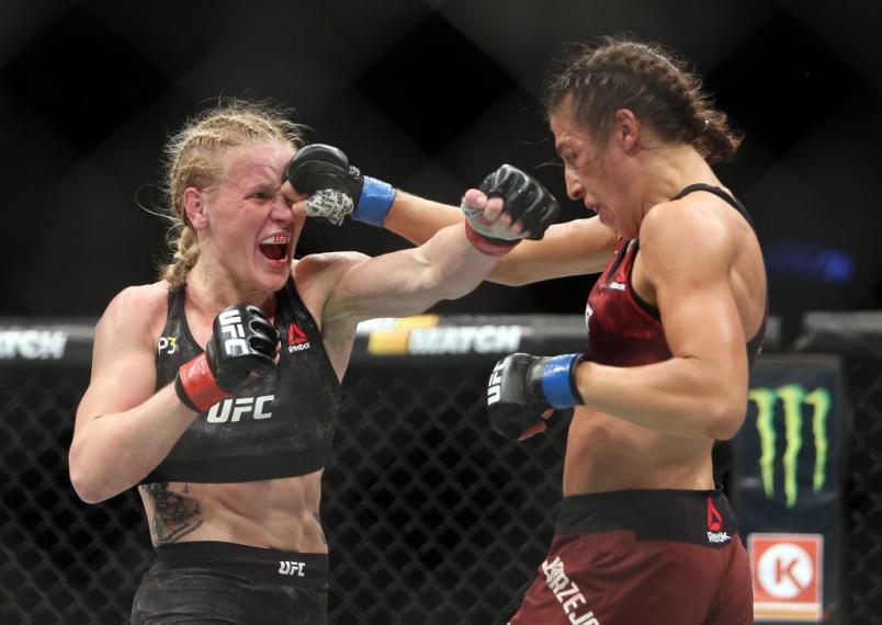 Joanna Jedrzejczyk of Poland fights against Valentina Shevchenko (L) of Kyrgyzstan in a flyweight bout during the UFC 231