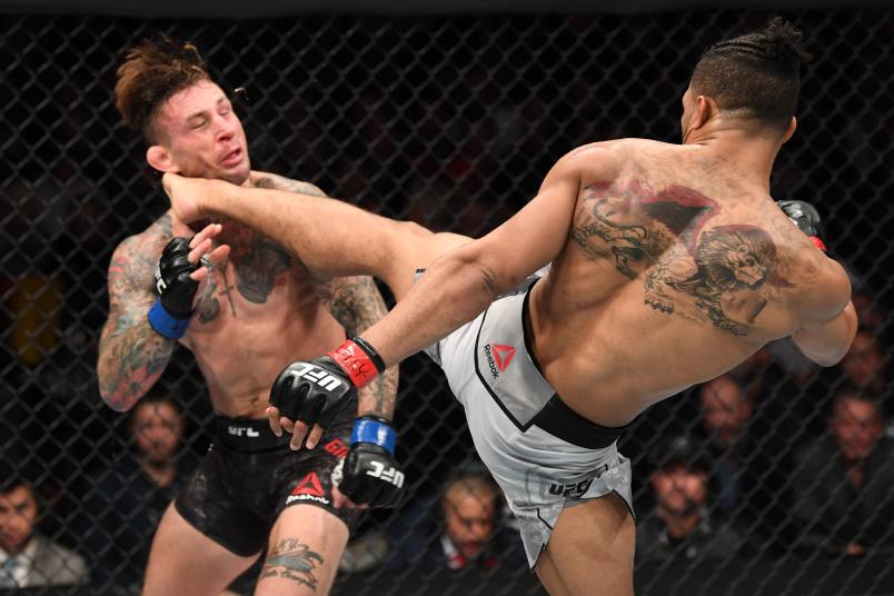 Kevin Lee kicks Gregor Gillespie in their lightweight bout during the UFC 244