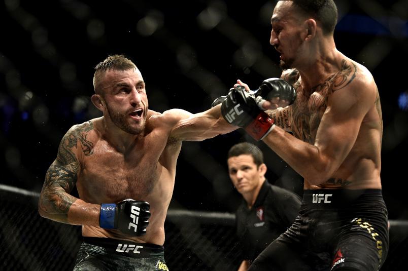lexander Volkanovski of Australia punches Max Holloway in their UFC featherweight championship bout during the UFC 245