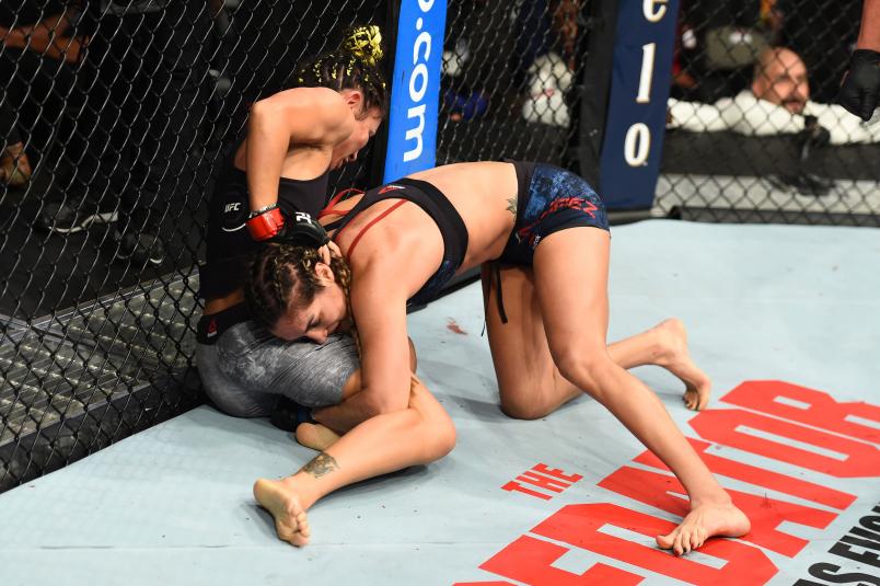 Tatiana Suarez takes down Carla Esparza in their women's strawweight fight during the UFC 228