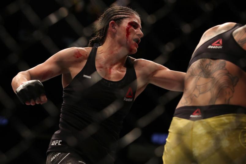 Julia Avila punches Pannie Kianzad of Sweden in their bantamweight fight during the UFC 239