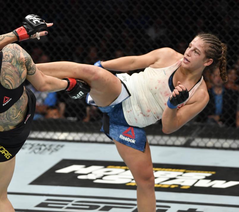 Felicia Spencer of Canada kicks Cris Cyborg of Brazil in their featherweight bout during the UFC 240