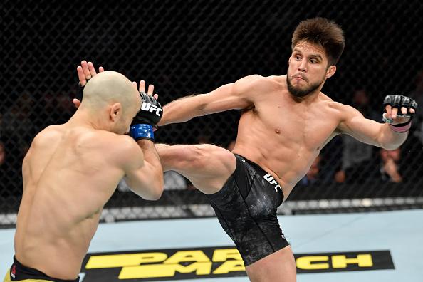 Henry Cejudo kicks Marlon Moraes of Brazil in their bantamweight championship bout during the UFC 238