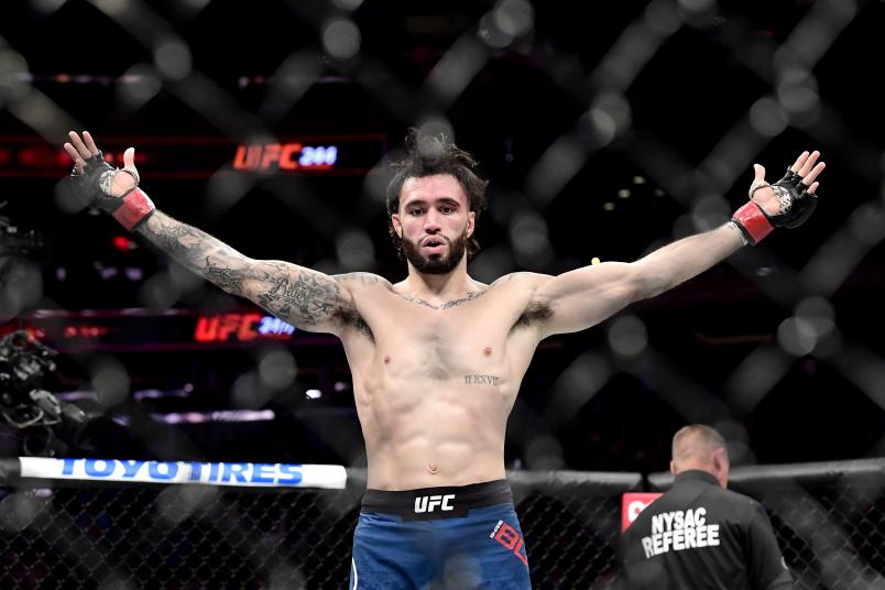 Shane Burgos of the United States celebrates victory against Makwan Amirkhani of Finland in the Light Heavyweight bout during UFC 244