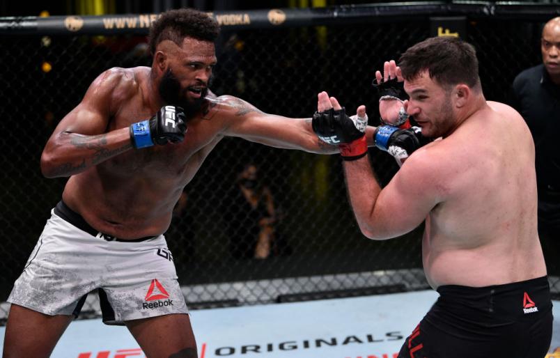 LAS VEGAS, NEVADA - JUNE 27: In this handout image provided by UFC, (L-R) Maurice Greene punches Gian Villante in their heavyweight fight during the UFC Fight Night