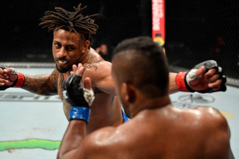 JACKSONVILLE, FLORIDA - MAY 09: (L-R) Greg Hardy punches Yorgan De Castro in their heavyweight fight during the UFC 249