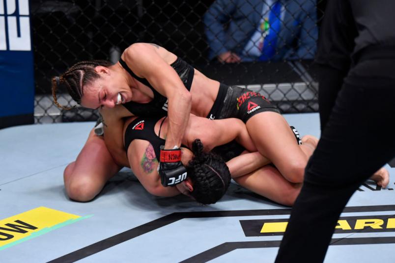 LAS VEGAS, NEVADA - NOVEMBER 21: Antonina Shevchenko of Kyrgyzstan (top) punches Ariane Lipski of Brazil in their women's flyweight bout