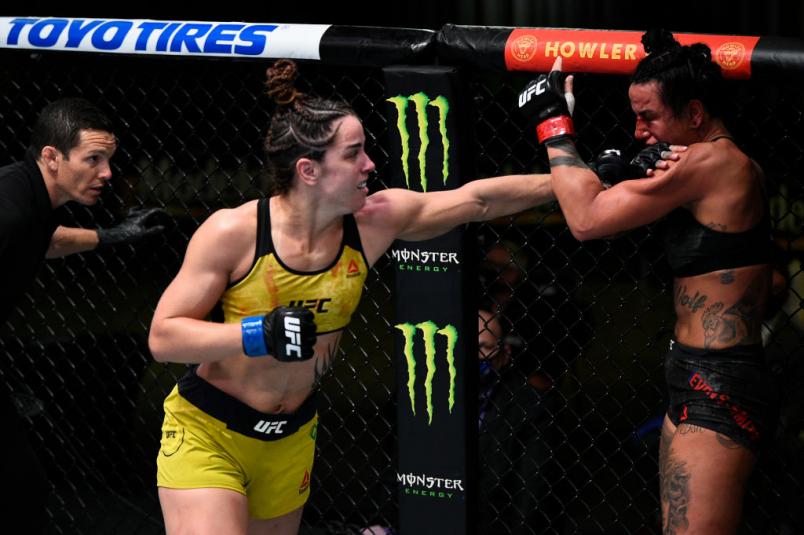 LAS VEGAS, NEVADA - NOVEMBER 28: (L-R) Norma Dumont of Brazil punches Ashlee Evans-Smith in their women's bantamweight bout during the UFC Fight Night