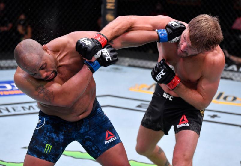 LAS VEGAS, NEVADA - AUGUST 15: (R-L) Stipe Miocic punches Daniel Cormier in their UFC heavyweight championship bout during the UFC 252