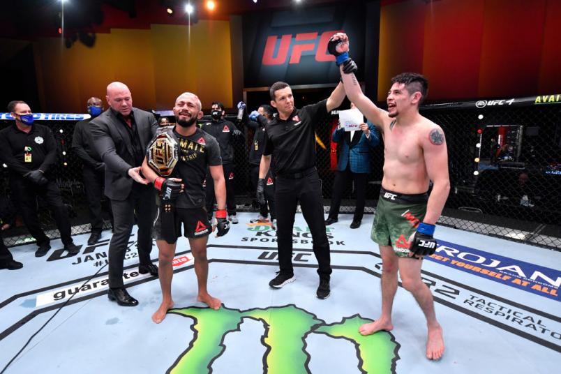 LAS VEGAS, NEVADA - DECEMBER 12: (L-R) Deiveson Figueiredo of Brazil and Brandon Moreno of Mexico react after their flyweight championship bout