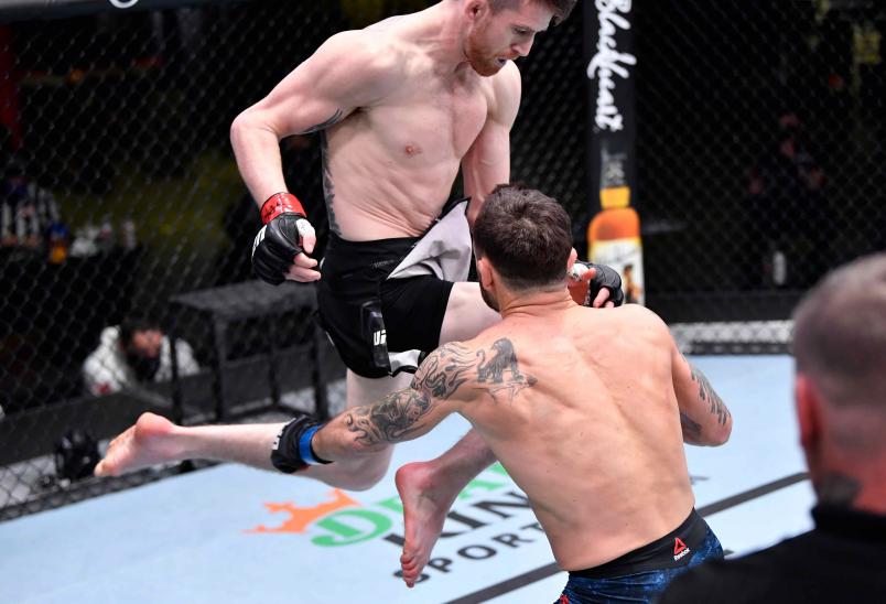 Cory Sandhagen lands a flying knee to knock out Frankie Edgar in their bantamweight fight during the UFC Fight Night event at UFC APEX on February 06 2021 in Las Vegas Nevada. (Photo by Chris Unger/Zuffa LLC)