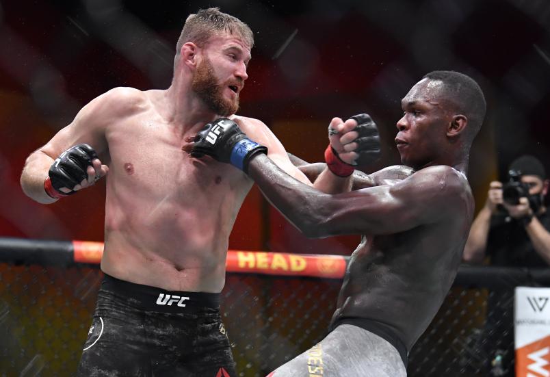 LAS VEGAS, NEVADA - MARCH 06: (L-R) Jan Blachowicz of Poland punches Israel Adesanya of Nigeria in their UFC light heavyweight championship fight during the UFC 259