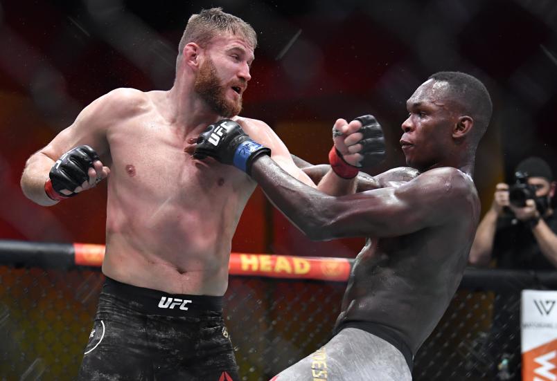 LAS VEGAS, NEVADA - MARCH 06: (L-R) Jan Blachowicz of Poland punches Israel Adesanya of Nigeria in their UFC light heavyweight championship fight during the UFC 259 