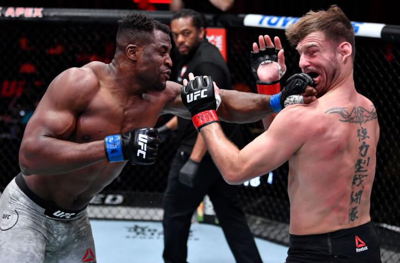 Francis Ngannou of Cameroon punches Stipe Miocic in their UFC heavyweight championship fight during the UFC 260 event at UFC APEX on March 27, 2021 in Las Vegas, Nevada. (Photo by Jeff Bottari/Zuffa LLC)