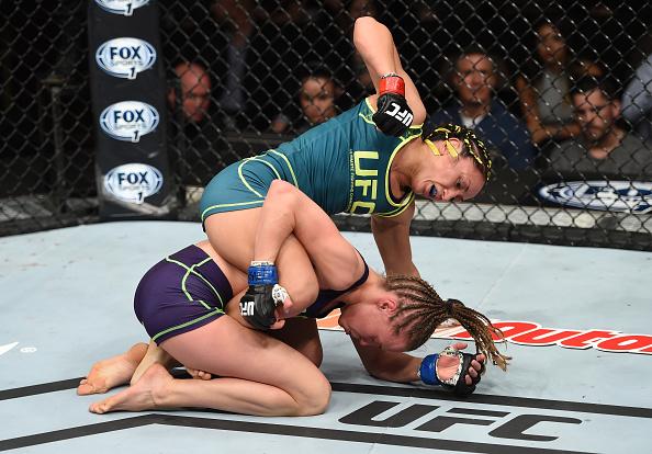 LAS VEGAS, NEVADA - DECEMBER 12: Carla Esparza (top) punches Rose Namajunas in their strawweight championship fight during The Ultimate Fighter Finale event inside the Pearl concert theater at the Palms Casino Resort on December 12, 2014 in Las Vegas, Ne