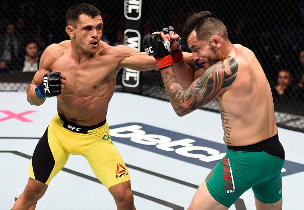 MEXICO CITY, MEXICO - NOVEMBER 05: (L-R) Douglas Silva de Andrade of Brazil punches Henry Briones of Mexico in their bantamweight bout during the UFC Fight Night event at Arena Ciudad de Mexico on November 5, 2016 in Mexico City, Mexico. (Photo by Jeff B