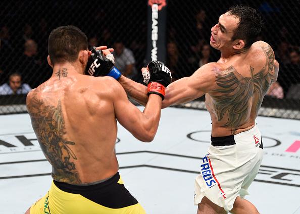 MEXICO CITY, MEXICO - NOVEMBER 05: (R-L) Tony Ferguson of the United States punches Rafael Dos Anjos of Brazil in their lightweight bout during the UFC Fight Night event at Arena Ciudad de Mexico on November 5, 2016 in Mexico City, Mexico. (Photo by Jeff