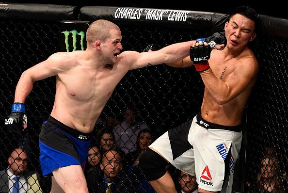 SACRAMENTO, CA - DECEMBER 17: Alex Morono punches James Moontasri in their welterweight bout during the UFC Fight Night event inside the Golden 1 Center Arena on December 17, 2016 in Sacramento, California. (Photo by Jeff Bottari/Zuffa LLC/Zuffa LLC via