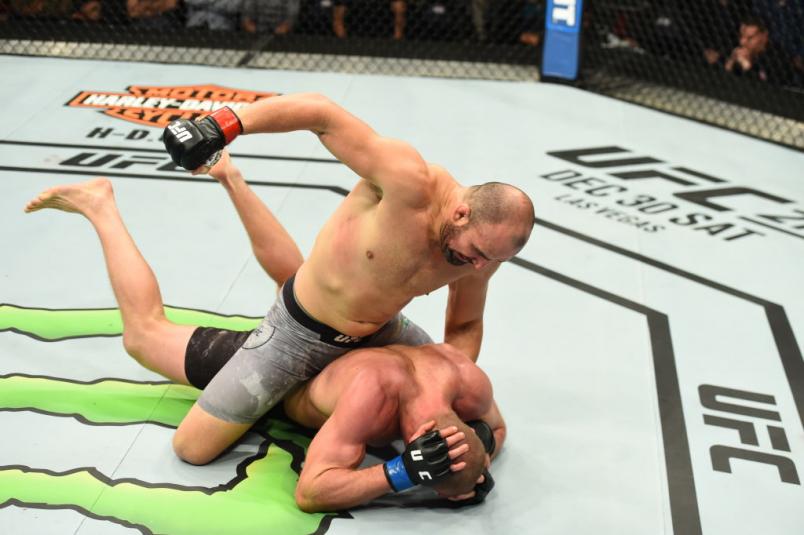 WINNIPEG, CANADA - DECEMBER 16: Glover Teixeira of Brazil (top) punches Misha Cirkunov of Latvia in their light heavyweight bout during the UFC Fight Night event at Bell MTS Place on December 16, 2017 in Winnipeg, Manitoba, Canada. (Photo by Josh Hedges/