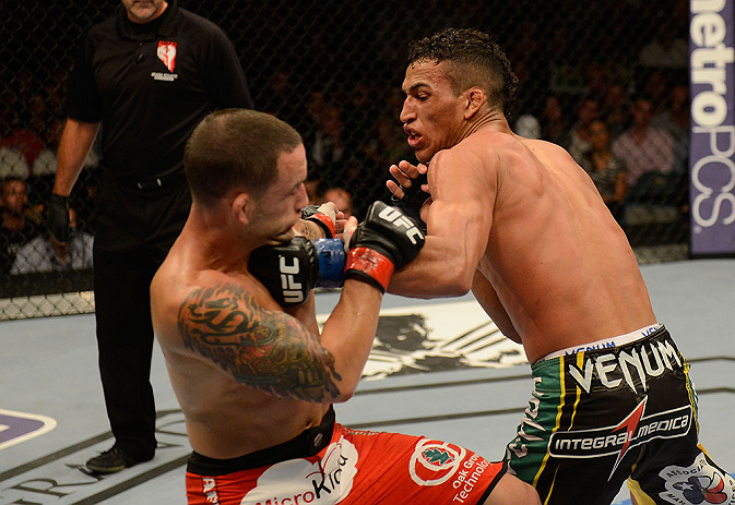 LAS VEGAS, NV - JULY 06: (R-L) Charles Oliveira punches Frankie Edgar in their featherweight fight during the UFC 162 event inside the MGM Grand Garden Arena on July 6, 2013 in Las Vegas, Nevada. (Photo by Donald Miralle/Zuffa LLC/Zuffa LLC via Getty Im