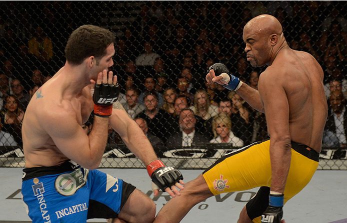 LAS VEGAS, NV - DECEMBER 28: (R-L) Anderson Silva kicks Chris Weidman in their UFC middleweight championship bout during the UFC 168 event at the MGM Grand Garden Arena on December 28, 2013 in Las Vegas, Nevada. (Photo by Donald Miralle/Zuffa LLC/Zuffa L