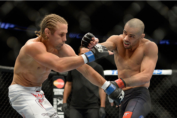 NEWARK, NJ - FEBRUARY 1: (R-L) Renan Barao punches Uriah Faber in their bantamweight championship fight during the UFC 169 event at the Prudential Center on February 1, 2014 in Newark, New Jersey. (Photo by Jeff Bottari/Zuffa LLC/Zuffa LLC via Getty Imag