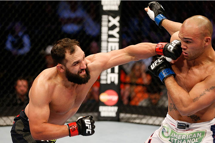 DALLAS, TX - MARCH 15: (L-R) Johny Hendricks punches Robbie Lawler in their UFC welterweight championship bout at UFC 171 inside American Airlines Center on March 15, 2014 in Dallas, Texas. (Photo by Josh Hedges/Zuffa LLC/Zuffa LLC via Getty Images)