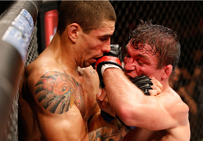 RIO DE JANEIRO, BRAZIL - OCTOBER 25: (R-L) Darren Elkins punches Lucas Martins of Brazil in their featherweight bout during the UFC 179 event at Maracanazinho on October 25, 2014 in Rio de Janeiro, Brazil. (Photo by Josh Hedges/Zuffa LLC/Zuffa LLC via G