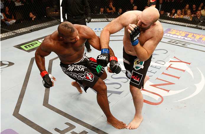 MASHANTUCKET, CT - SEPTEMBER 05: (R-L) Ben Rothwell lands an overhand right to the head of Alistair Overeem in their heavyweight bout during the UFC Fight Night event at Foxwoods Resort Casino on September 5, 2014 in Mashantucket, Connecticut. (Photo by
