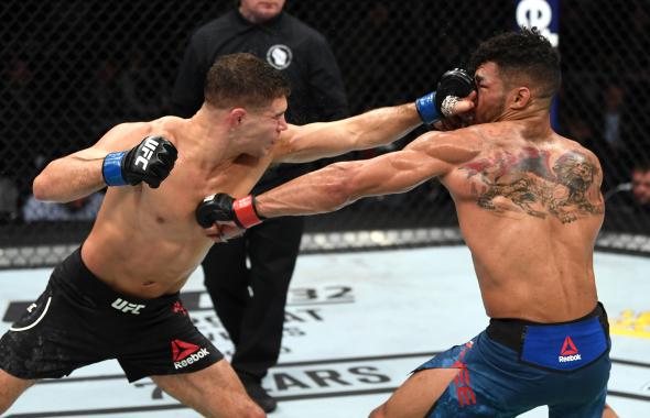 Al Iaquinta punches Kevin Lee in their lightweight bout during the UFC Fight Night event at Fiserv Forum on December 15, 2018 in Milwaukee, Wisconsin. (Photo by Jeff Bottari/Zuffa LLC)