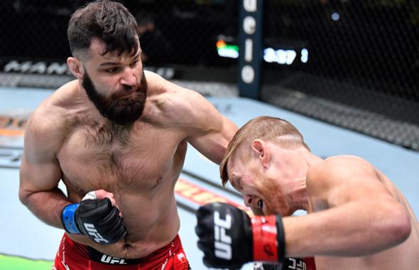 Julian Marquez punches Sam Alvey in a middleweight fight during the UFC Fight Night event at UFC APEX on April 10, 2021 in Las Vegas, Nevada. (Photo by Chris Unger/Zuffa LLC)